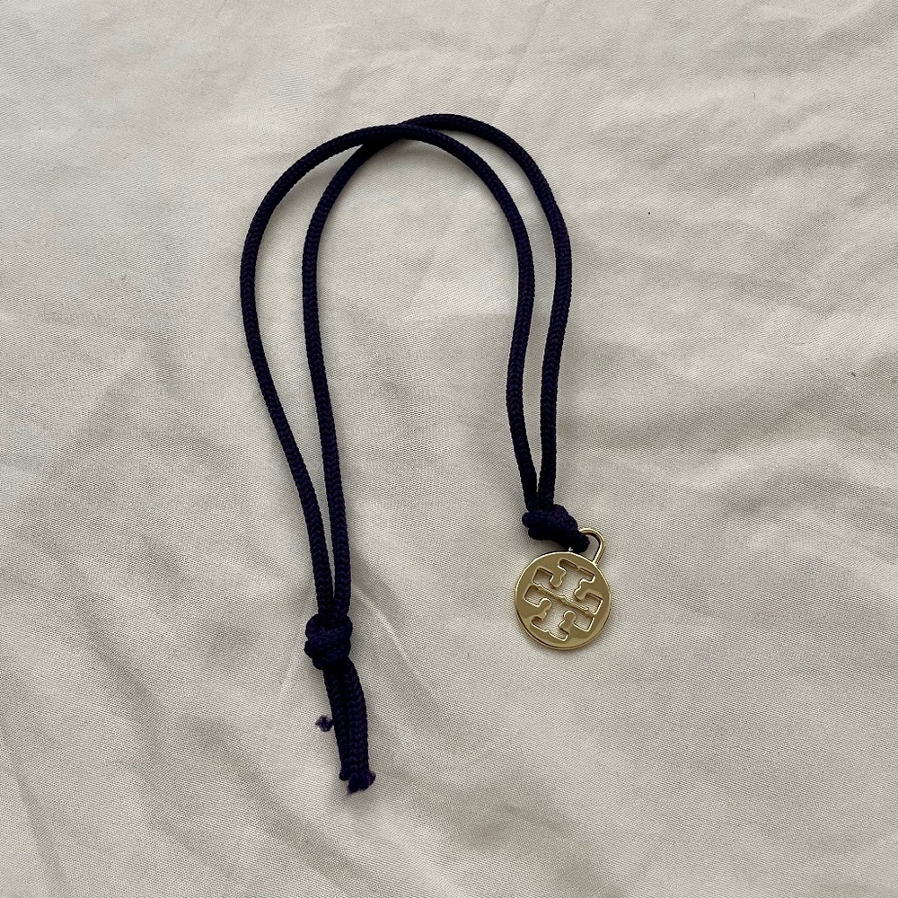 Tory Burch Gold Charm On Purple String From Dust Bag